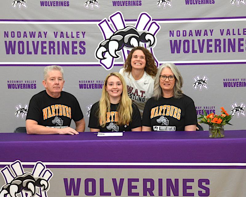 Joined by parents Brian and Laura Britten and SWAT girls wrestling coach Tiffany South, Grace Britten signs to wrestle at Wartburg College in Waverly.