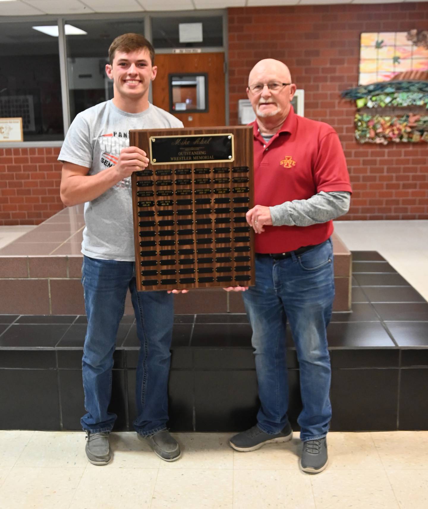 Denny Abel presents Lane Travis with the 2026 Mike Abel Outstanding Wrestler award