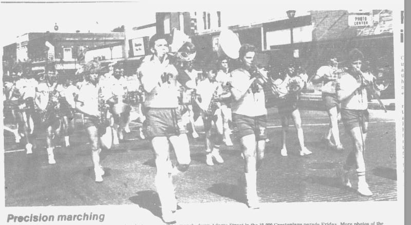 Members of the Creston High School marching band play on as they march down Adams Street in the 10,000 Crestonians parade Friday.