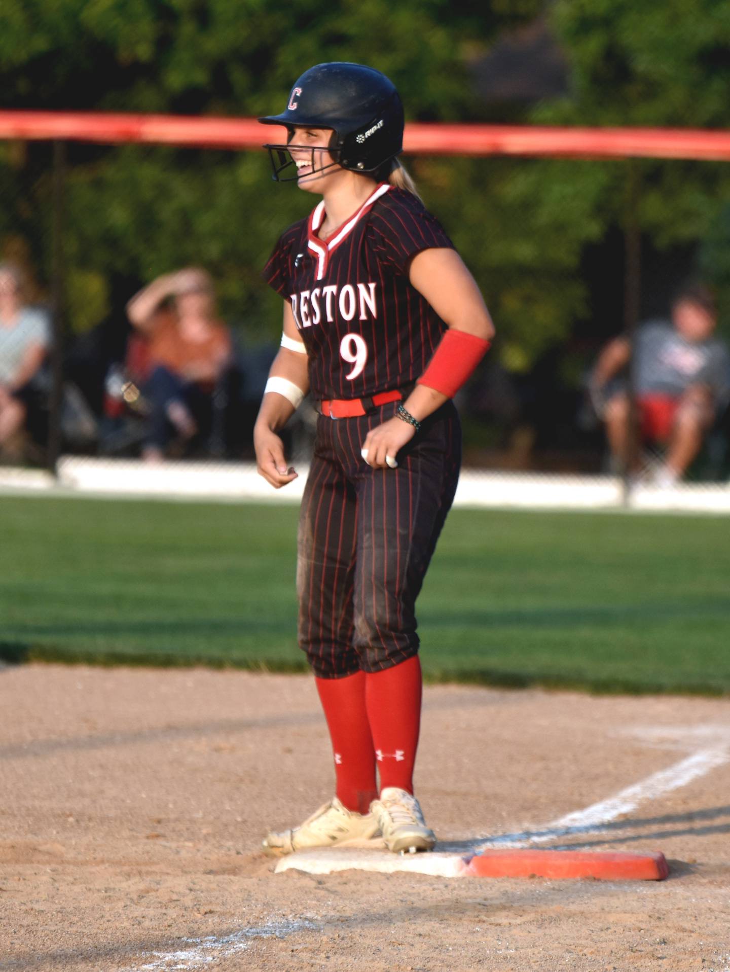 Creston's Evy Marlin smiles after her base hit.