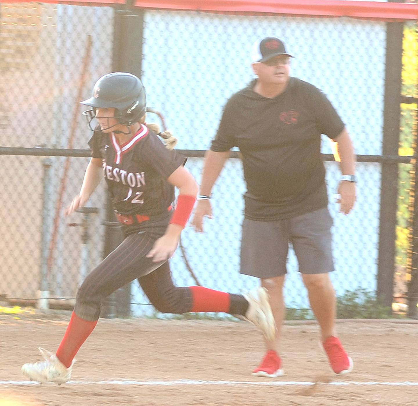 Creston's Sasha Wurster heads home on Ava Adamson's RBI single in the third inning of Tuesday's win over Greene County. Wurster had a double and RBI on senior night.