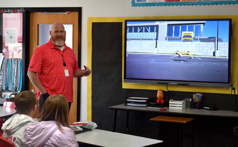 Jon Thomson teaches his computer science class about Spot, the robot dog created by Boston Dynamics.