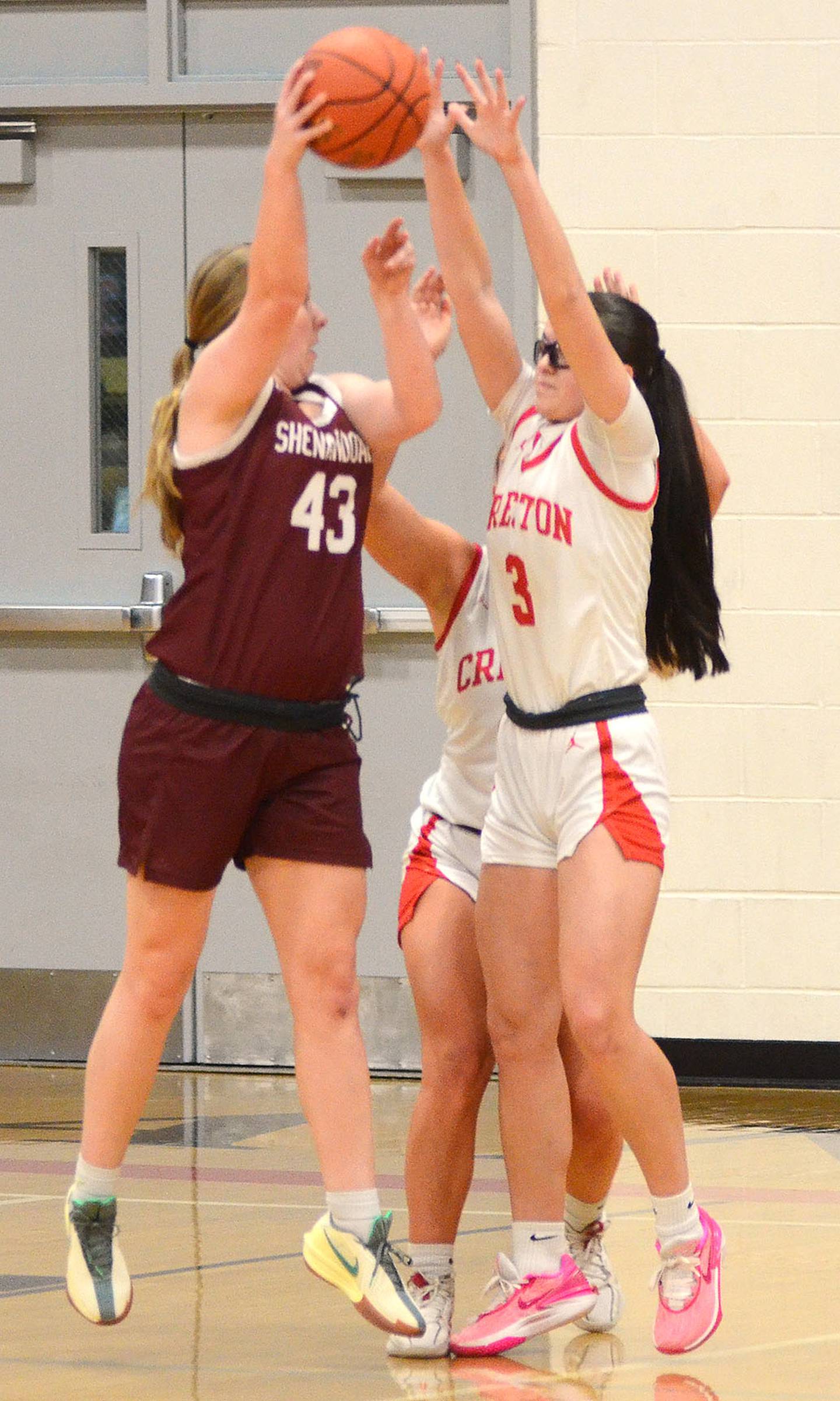 Braylee Pokorny of Creston blocks a shot attempt by Addison 
Estes of Shenandoah. Pokorny had a team-high nine rebounds and five points in the loss.