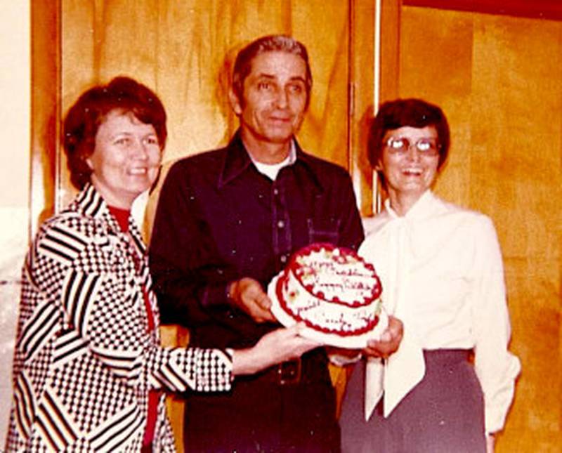 Siblings Carolyn Skarda, Merrill Crittenden and Linda Moore display their shared birthday cake circa 1975. Skarda and Moore each have Christmas Day birthdays. Crittenden was born on a Christmas Eve.