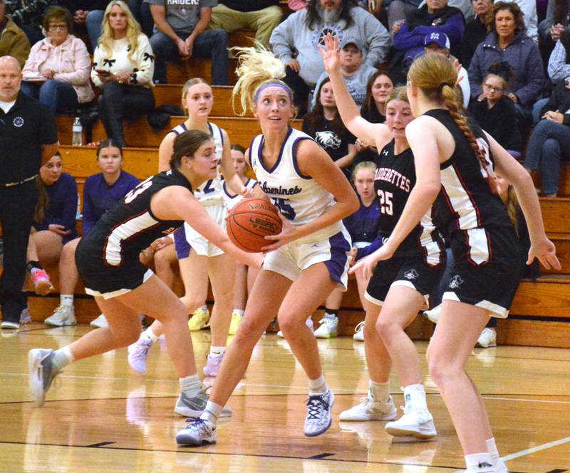 Mount Ayr's defense confronts Nodaway Valley junior Izzy Eisbach in the lane during a girls basketball game this season.