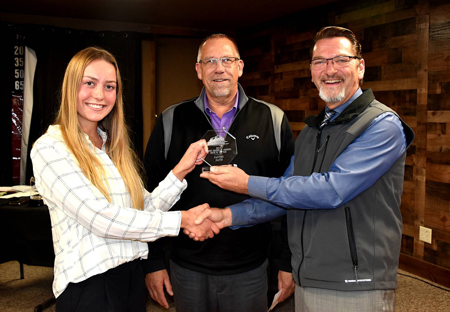 Creston High senior Payton Davis, receives the Creston Chamber of Commerce Student of the Year award from Mittag and Pearson.