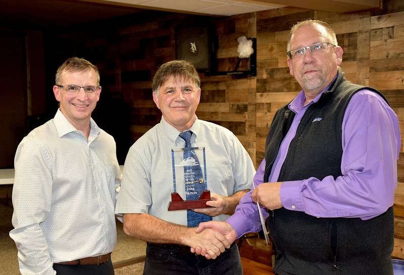 John Walters, center, receives the Creston Chamber of Commerce 2023 Citizen of the Year Award Tuesday from chamber board president Darin Goins, left, and chamber member Craig Mittag.