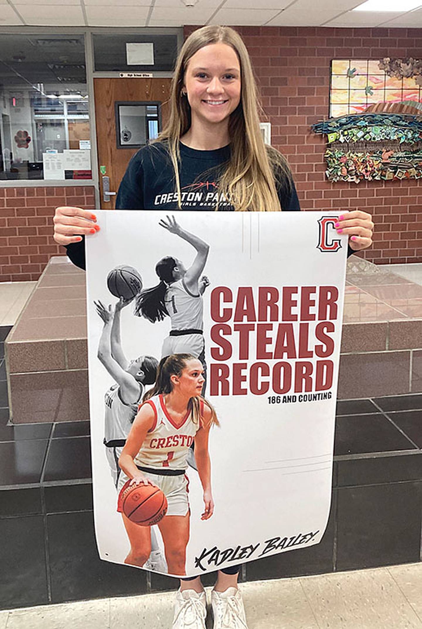 Creston junior Kadley Bailey was presented a poster signifying her achievement as new career steals record-holder with 186 career steals, surpassing Brielle Baker's record of 184.