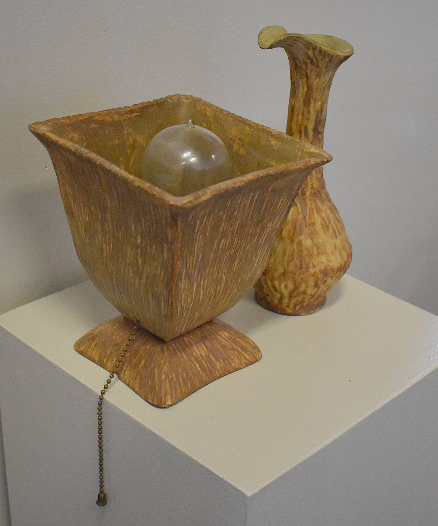 A table lamp and a water jug made by Susan Conrad.