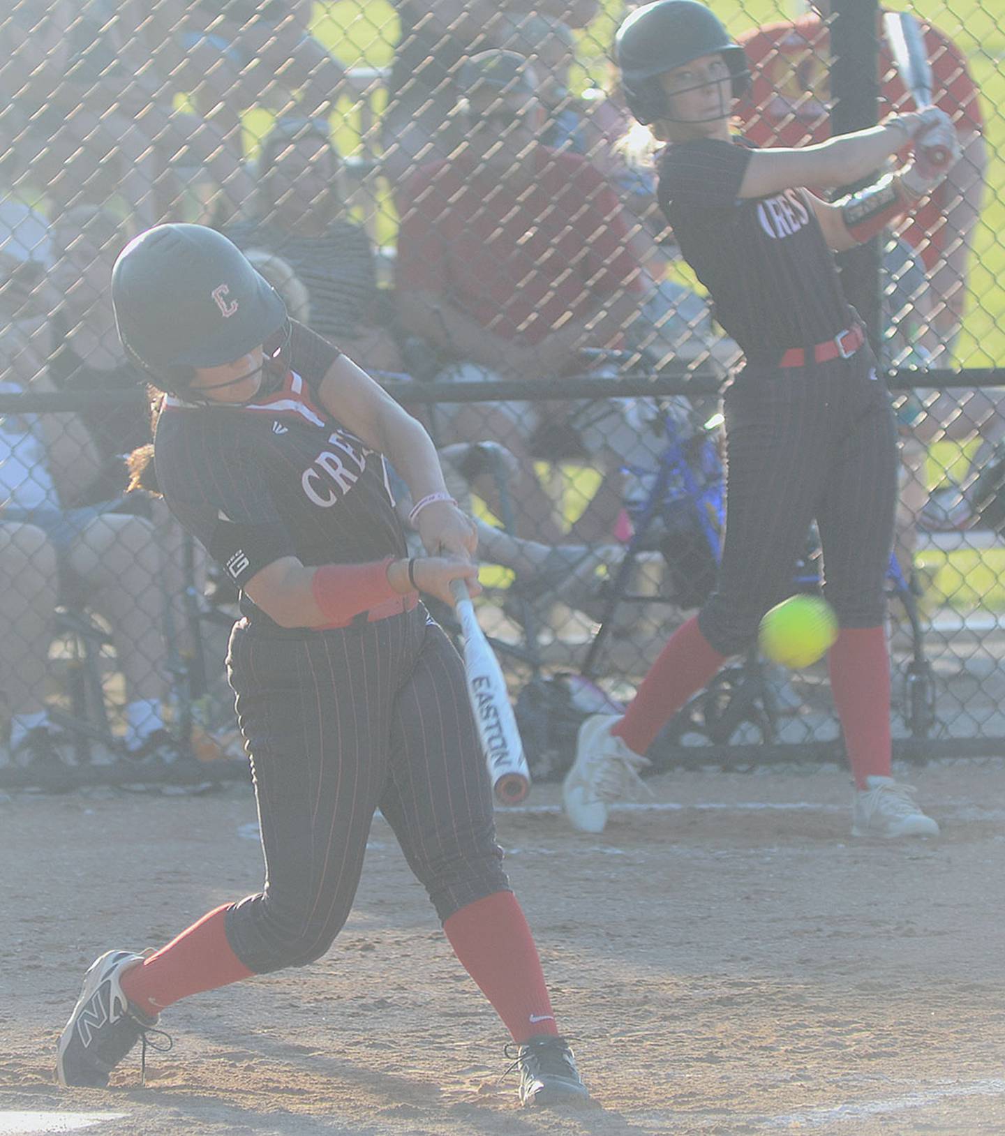 Mila Kuhns of Creston connects with a sacrifice fly in the first inning of Tuesday's 14-1 victory. Later in the game Kuhns hit a home run for the second consecutive night for the Panthers.