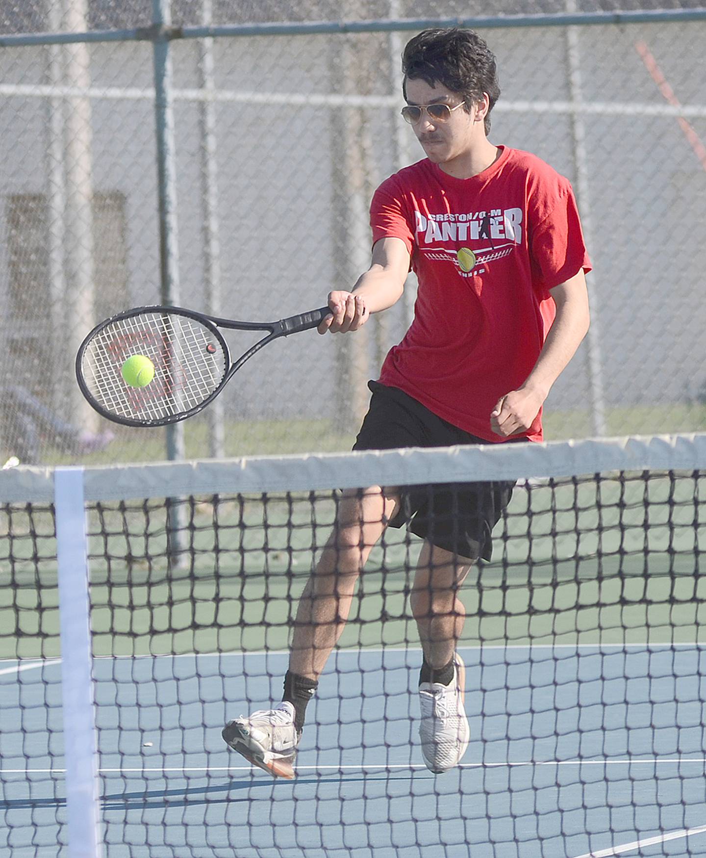 Creston's Ben Hill hits a forehand shot against Chariton Monday. Hill teamed with Damion Meyer for an 8-4 doubles win in the team's 6-3 dual victory.