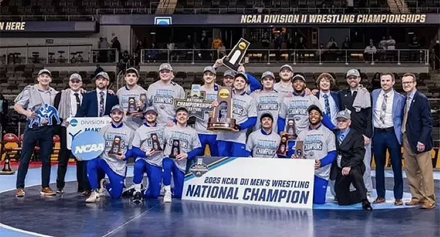 The Nebraska-Kearney wrestling team with the NCAA Division II championship trophy and All-American awards.
