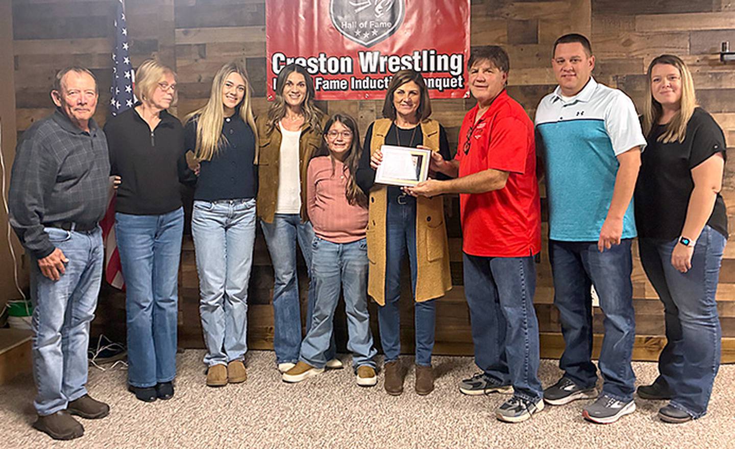 Deb Veitz, wife of the late Gary Veitz, accepts the Hall of Fame plaque honoring Gary's induction from committee member John Walters, along with the rest of the Veitz family. Walters was a teammate of Gary Veitz.