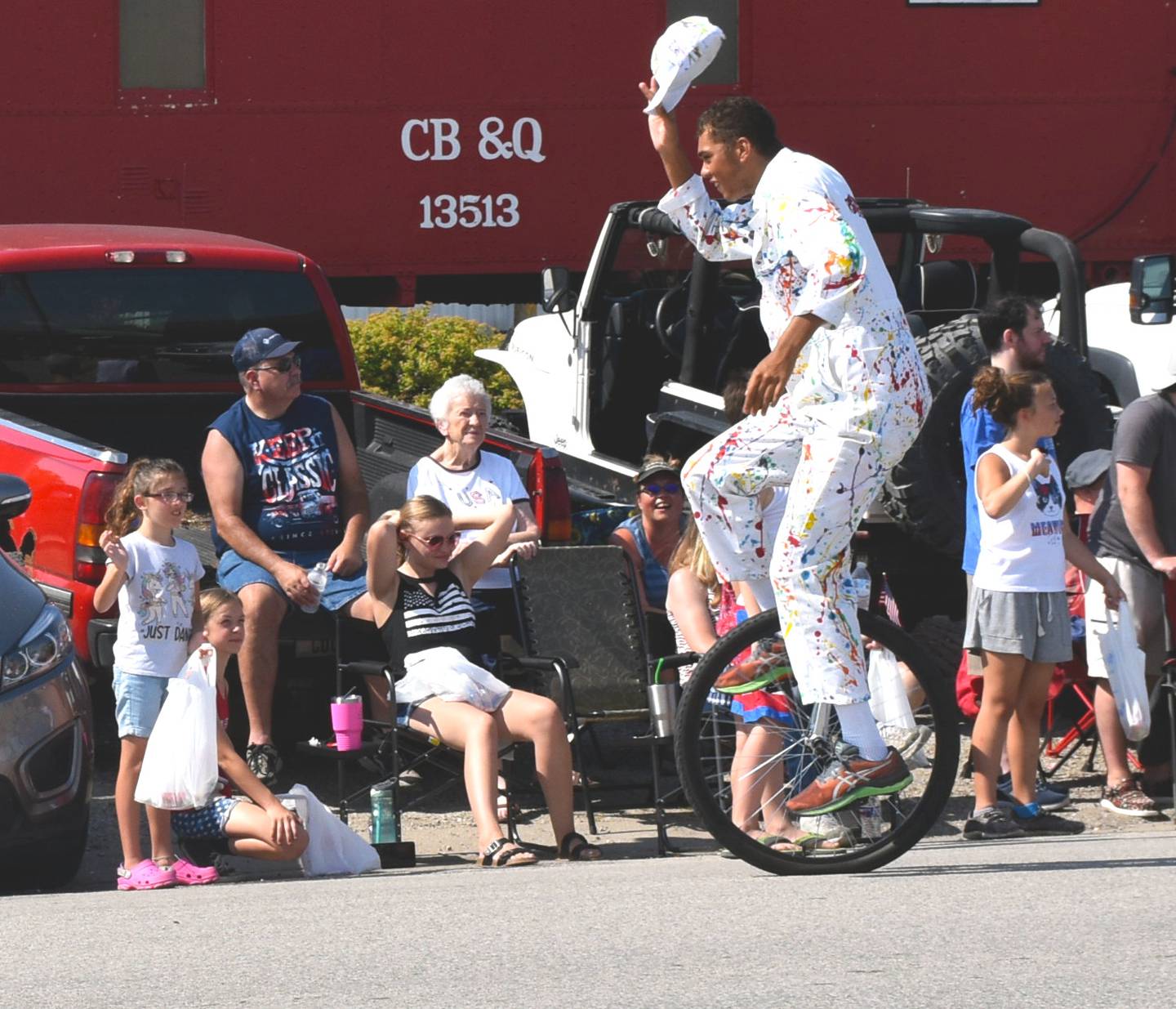 Ralston entertains the crowd as he rides a unicycle in a July Fourth parade in Creston.