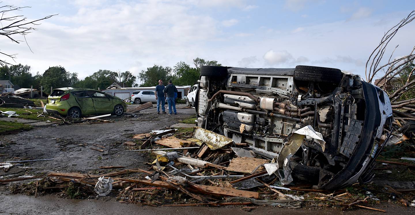 A truck lies on its side after being lifted and displaced. The tornado on Tuesday lifted vehicles and wailed debris toward homes.