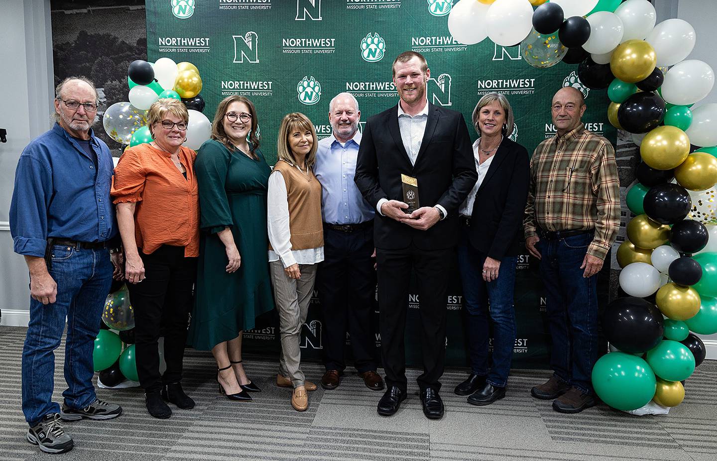 Collin Bevins is shown with family members at the M-Club Hall of Fame ceremony. Shown from left, Collin's uncle Pat and aunt Sheila Bevins, his sister Michaela Biggart, stepmother Deena Bevins and father Jeff Bevins, Collin Bevins, Collin's mother Michelle Bevins and stepfather Gordy Bunch. Collin's brother, Jared Bevins, was coaching in the Iowa high school football playoffs for Wayne of Corydon on the night of the ceremony.
