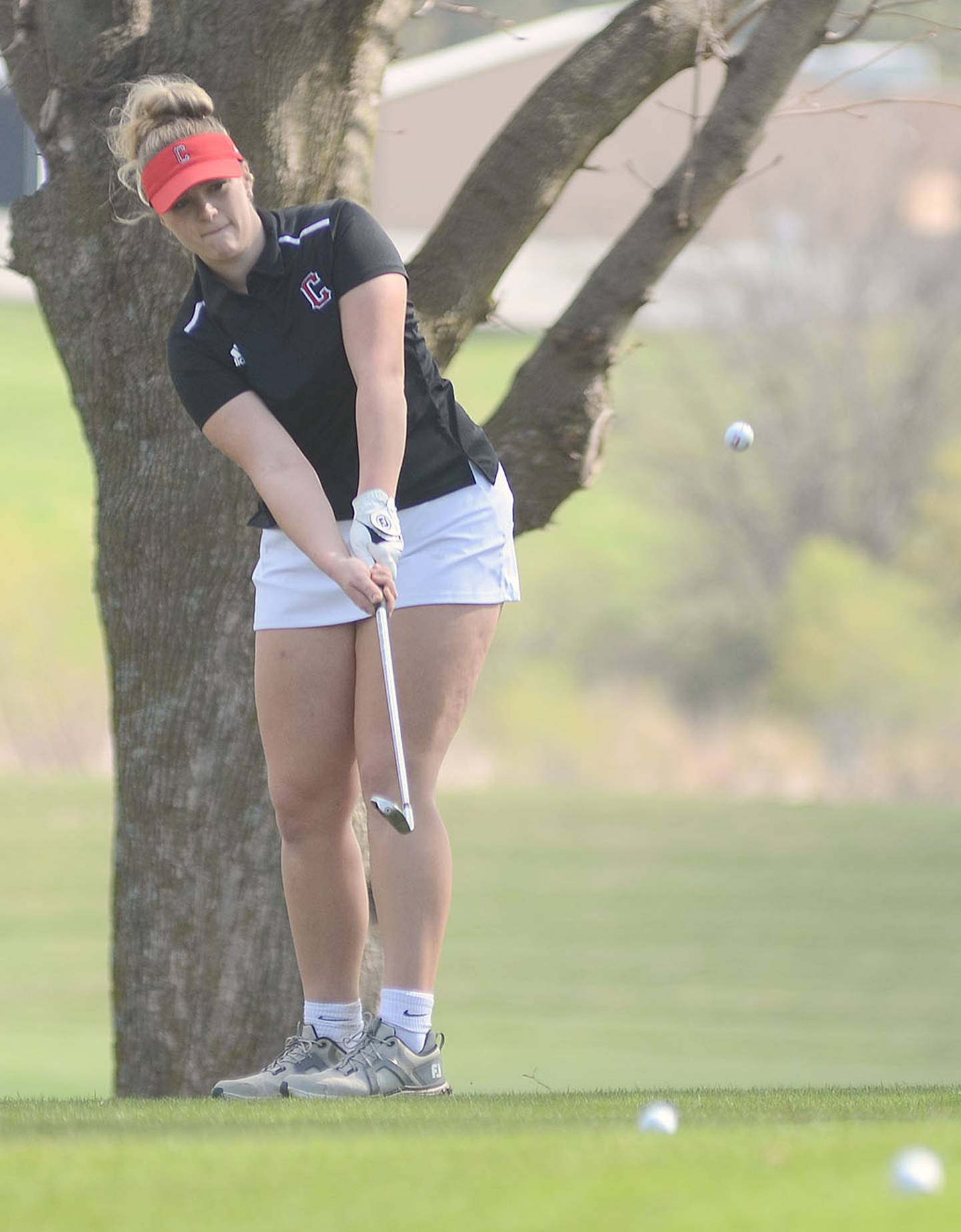 Ricci Johnston of Creston chips onto the No. 3 green at Crestmoor Golf Club. Johnston was Creston's leader in shooting 53-58 — 111.