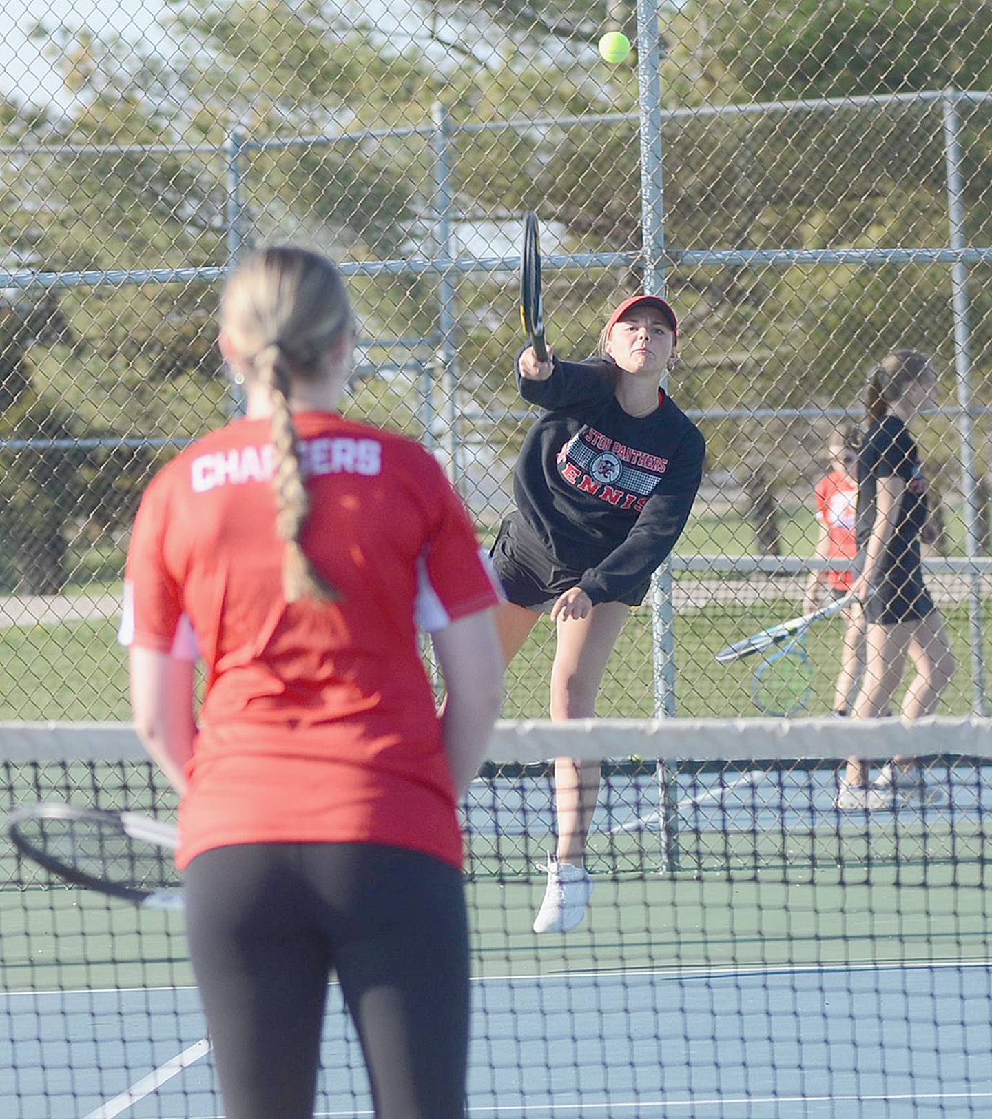 Creston's Ava Adamson sends a serve into the Chariton court during doubles play. Adamson also won 8-0 at No. 1 singles before teaming with Kennedy Strider for the doubles victory.