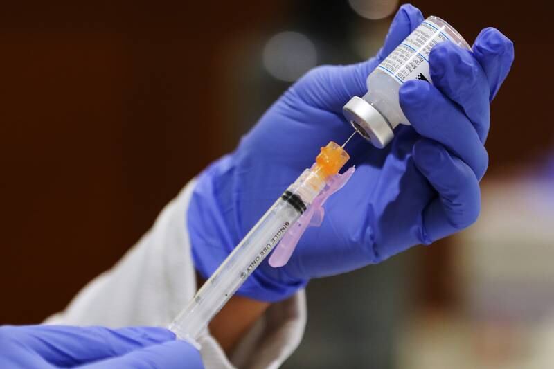 A medical assistant fills a new syringe at the Moderna COVID-19 vaccination clinic at the District 300 Central Office on Harnish Road on Thursday, Feb. 4, 2021 in Algonquin.  Teachers filtered in five at a time every fifteen minutes to get the first of two dosages of the Moderna COVID-19 vaccine.