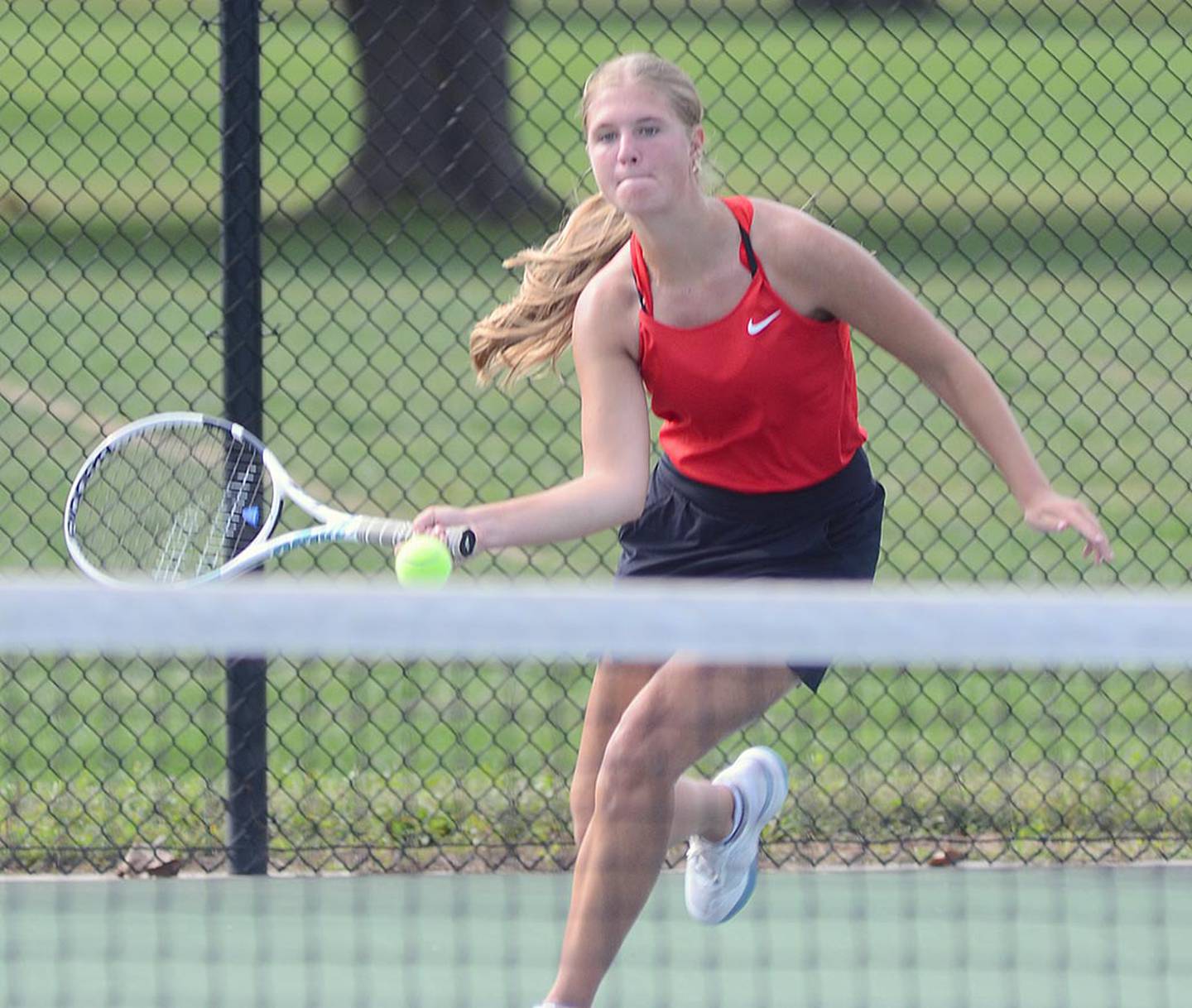 Marlee Stalker of Creston approaches a forehand shot during No. 1 singles competition at the Hawkeye Ten tournament. Stalker won her first round match, 8-6.