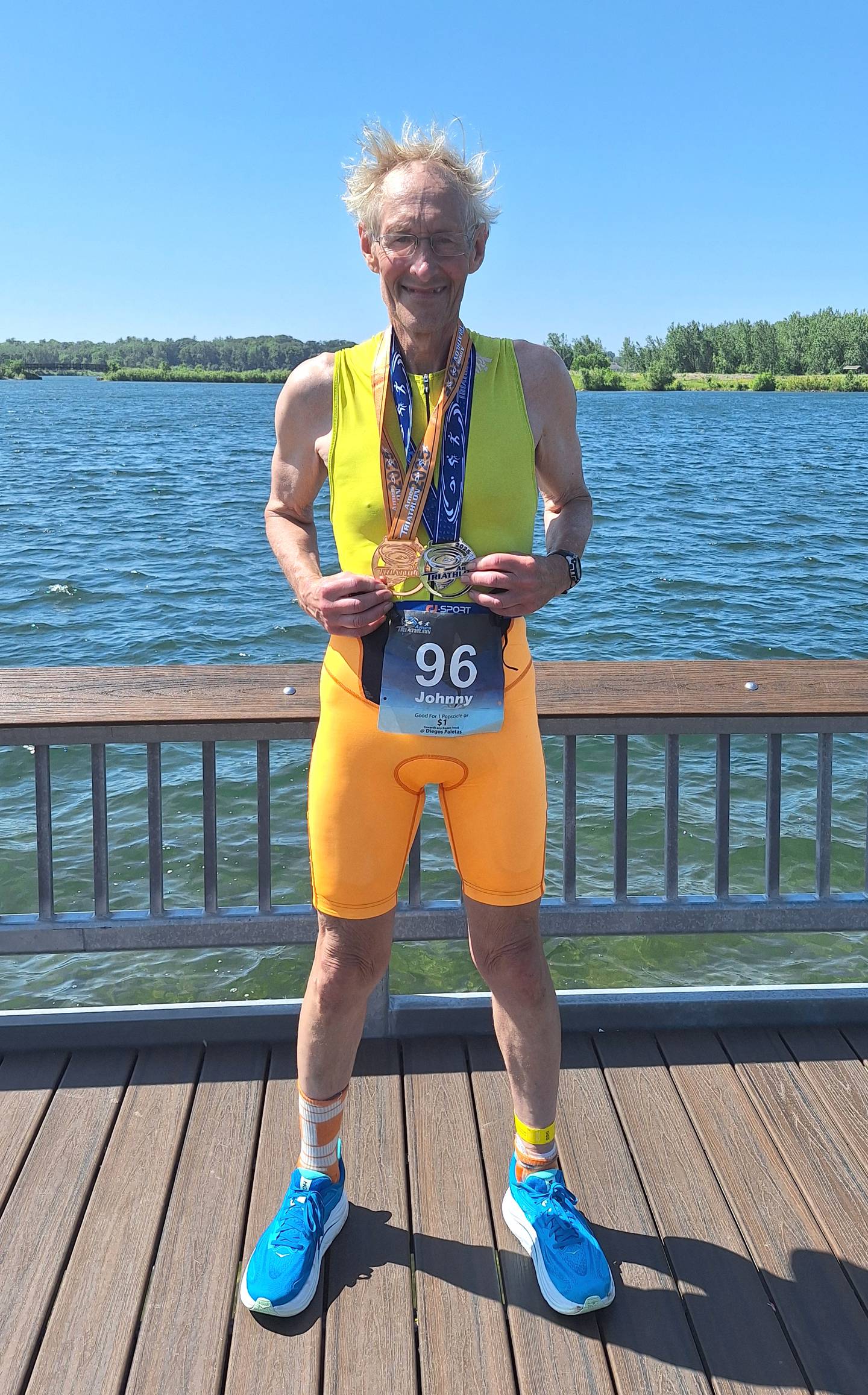 Ytzen poses with his medals for finishing and placing in his age group at the Ames Triathlon last year.