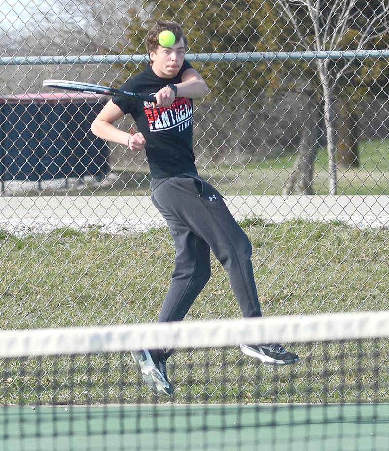 Damion Meyer of Creston leaps to complete a baseline shot during his 8-1 victory at No. 4 singles Friday.