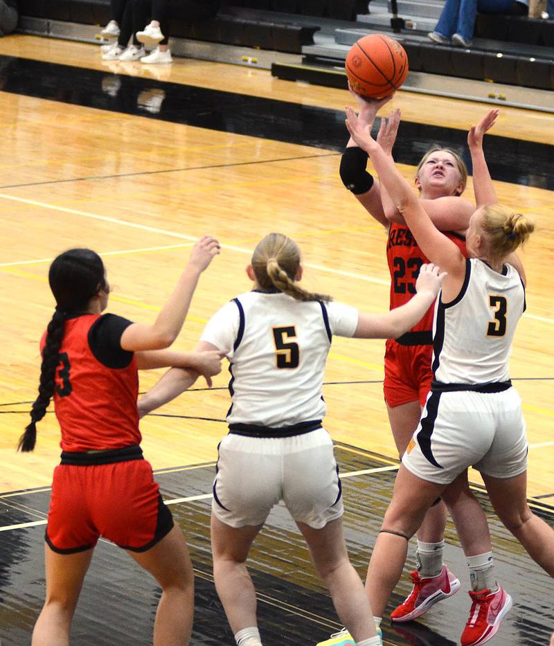 Creston center Brynn Tussey (23) shoots over Winterset's Natalie Smith (3) during Monday's 57-34 loss. At left are Winterset's Abby Hoefing (5) and Braylee Pokorny of Creston (3). Tussey finished with five points and five rebounds.