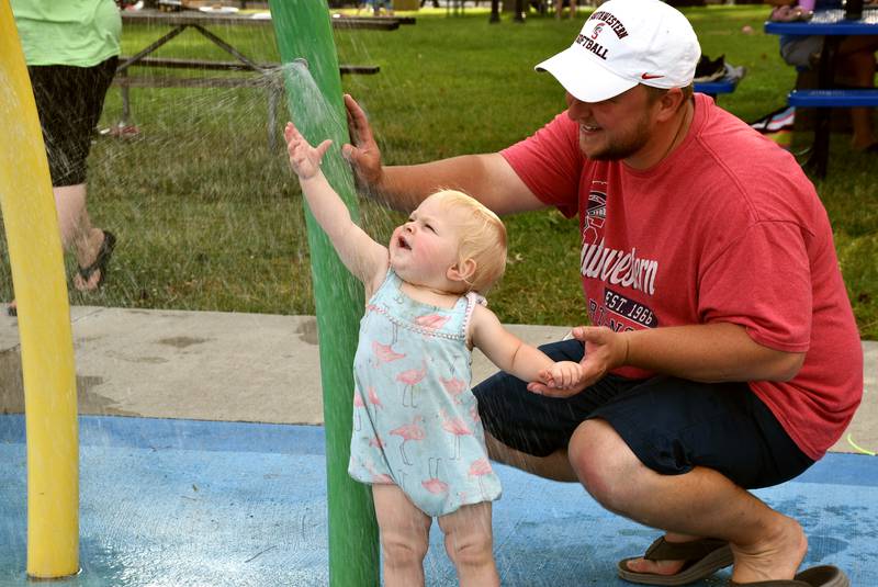 Doug North and daughter Willow play at Afton's splash pad in 2022. Afton City Council is considering either replacing existing playground equipment in the square or building a new playground near the rec field.