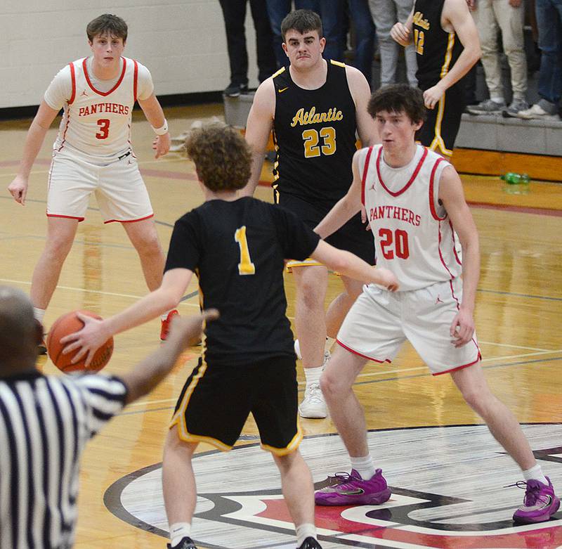 Creston's Jaxson Jondle (20) and Rhett Driskell (3) play defense in the Panthers' halfcourt press against Atlantic point guard Gage Gross (1) during the fourth quarter Monday. The Panthers closed on a 5-0 run to win, 63-58.
