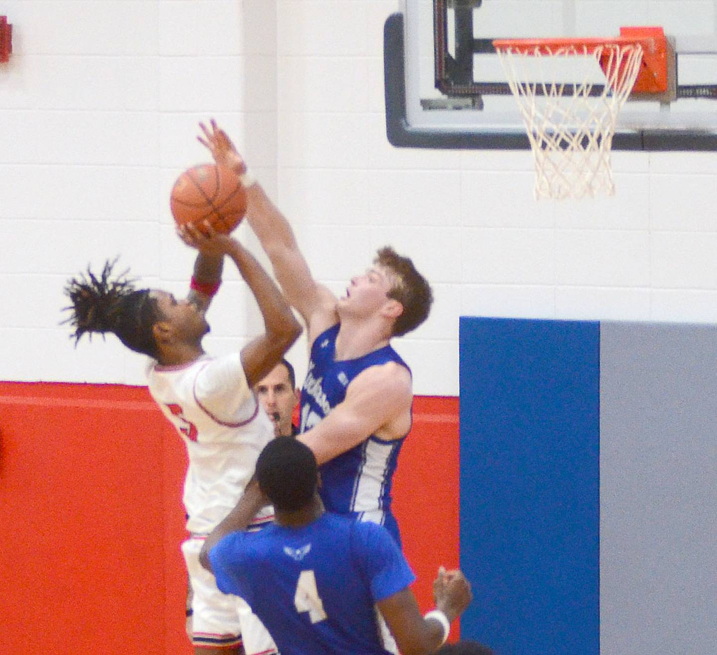 Kirkwood's Cole Marsh contests a short-range shot by Michael Smith of Southwestern during Thursday's game. Smith scored five points in the 81-58 conference loss.