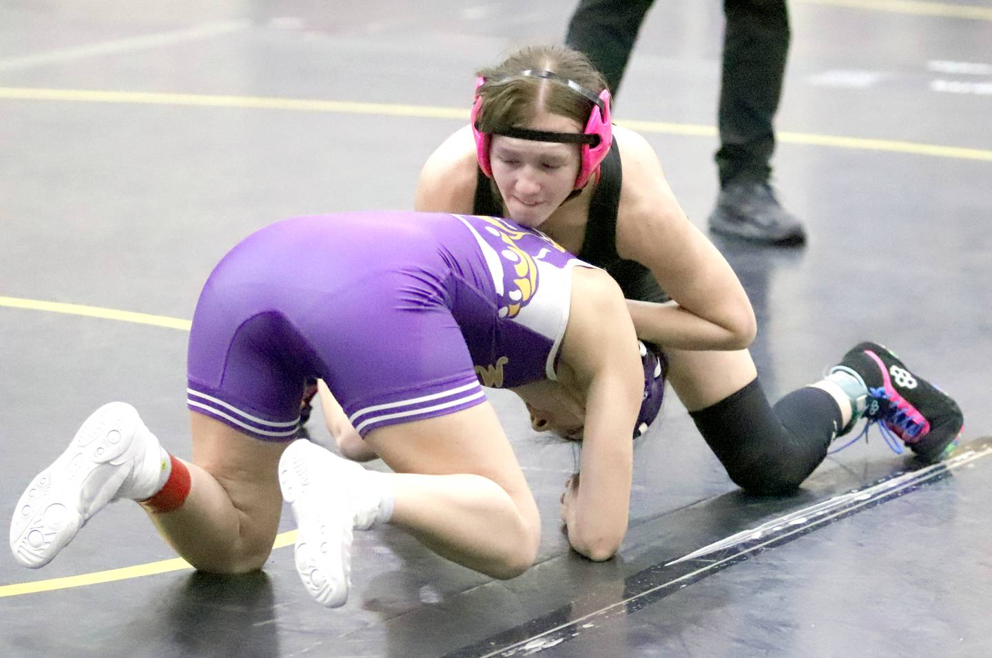SWAT senior Jazz Christensen of Nodaway Valley (top) works to turn an opponent during the Atlantic tournament Saturday, Jan. 25.