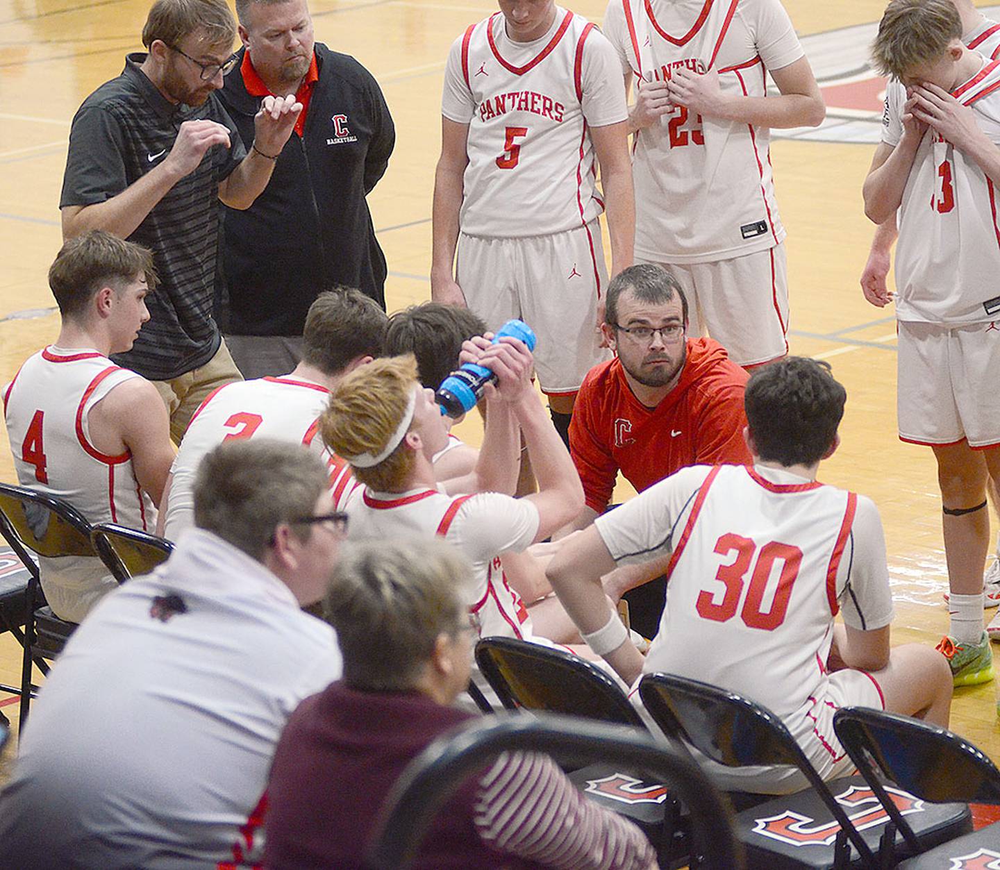 Creston coach Bryce Schafer makes a point with Jaxson Schaffer (30) during a timeout Monday. The Panthers outscored Atlantic 18-12 in the fourth quarter.