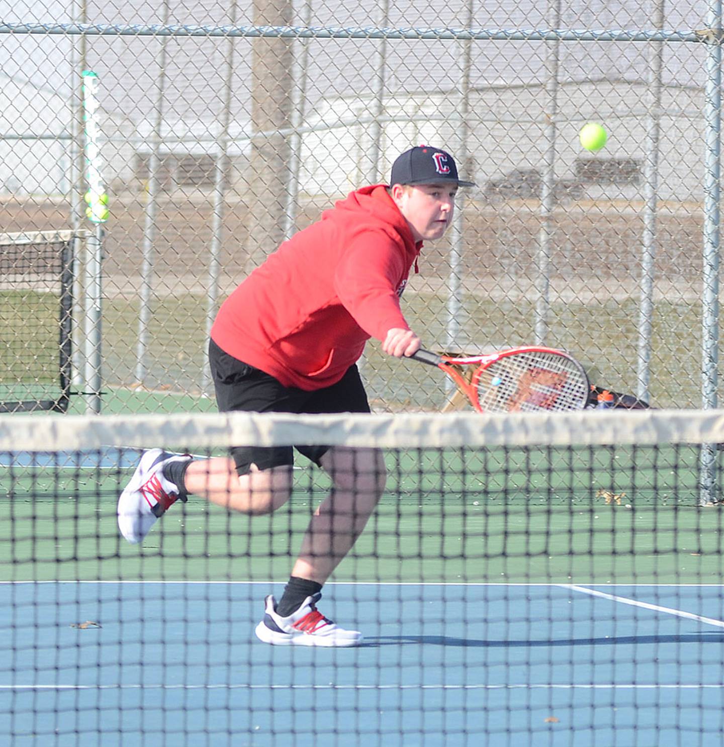 Creston's Dylan Dornack reaches to return a shot during his No. 5 singles match Tuesday. Dornack and Carson Beer  competed well in No. 3 doubles, falling 8-6.