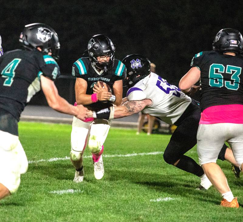 NV/OM senior Ashton Honnold (middle) meets SWV ball carrier Cael Hogan at the line of scrimmage in last Friday's game at Corning.