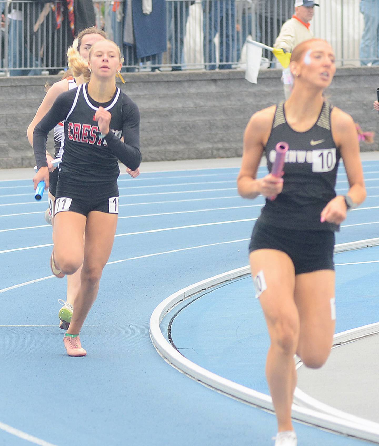 Cora Smith of Creston closes on Glenwood's anchor runner on the final curve, surpassing her with about 60 meters remaining as the Panthers earned eighth-place medals in a time of 9:47.24.