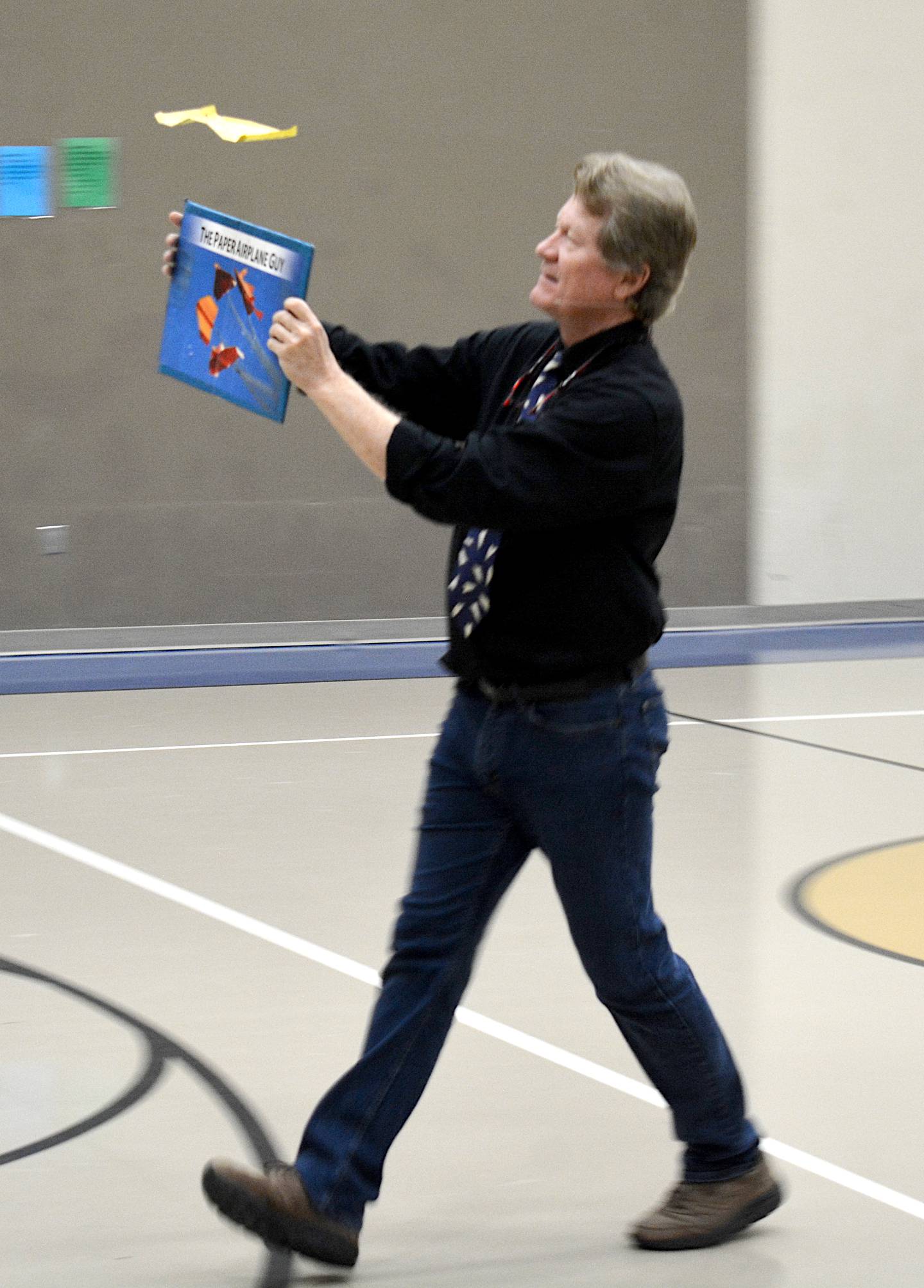 John Collins briskly "walks" his paper airplane, using the board to keep it afloat. As long as there is airflow underneath the plane, it will stay afloat.