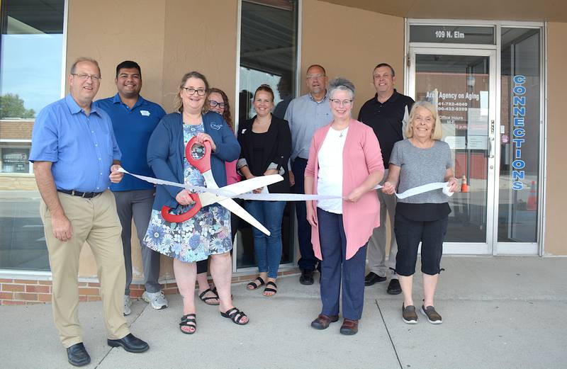 Members of Connections AAA stand in front of the Connections AAA office during a ribbon cutting last Wednesday.