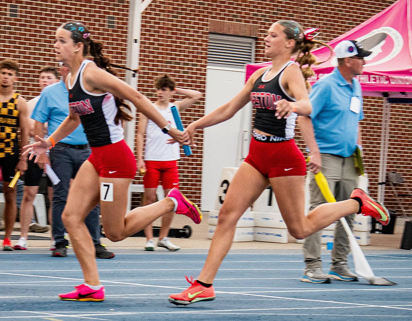 Kadley Bailey (right) hands the baton to fellow senior Braylee Pokorny to finish the 4x100 relay. Creston placed 15th in 50.01.
