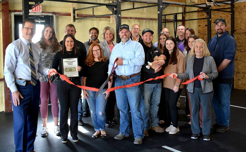 Staff of Champion Fitness and members of the Creston Chamber of Commerce join together for the ribbon-cutting of the new business.