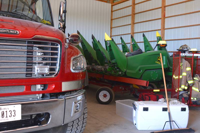 A corn head for a combine sits next to a Greenfield fire truck in a temporary facility Bill Hohertz made available to the fire department while they figure out a more permanent home after the May 21 tornado heavily damaged their station.
