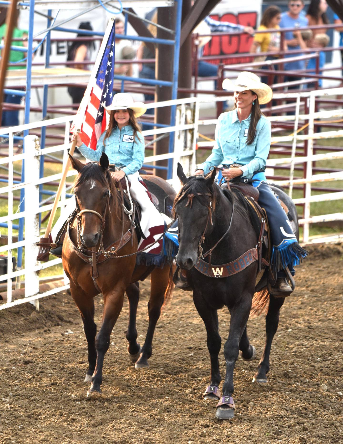 The American flag is carried around the grandstand arena before the rodeo in 2024.