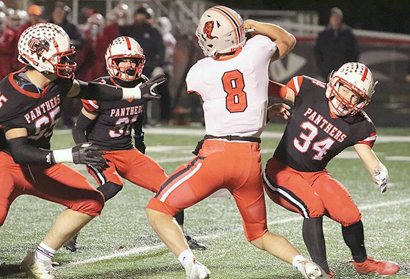 Creston defensive players Milo Staver (34), Jackson Kerr (65) and Dylan Calvin (31) converge on Harlan quarterback Will Arkfeld last week in the Panthers' 35-27 victory. Gang tackling will be essential Friday against Webster City's rushing attack that has produced 2,253 yards (6.6 yards per carry) this season.