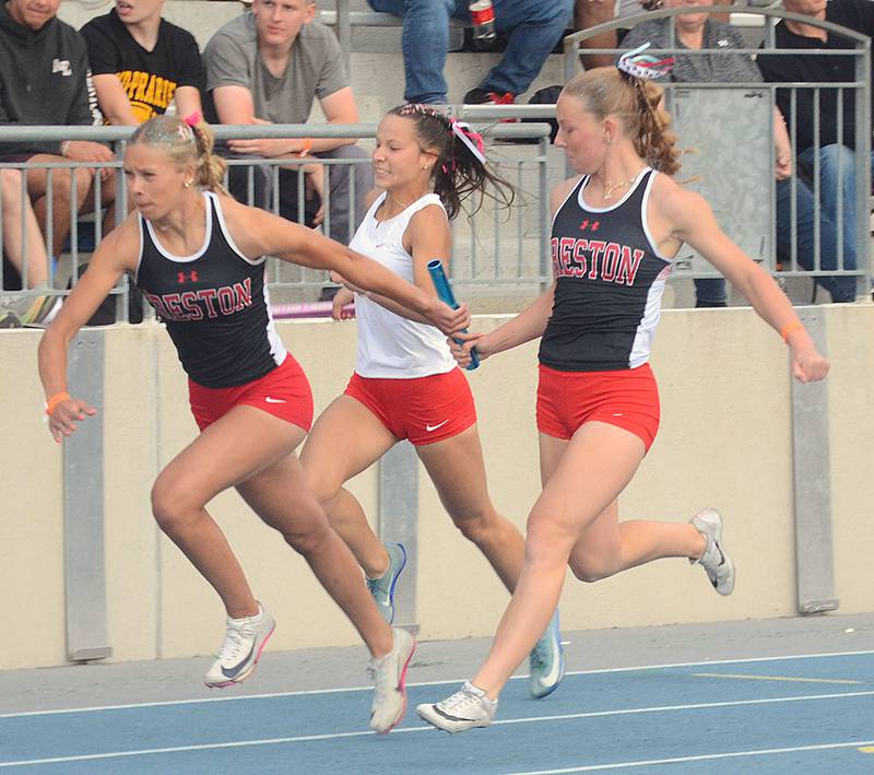 Creston's Cora Smith takes the baton from Avery Staver in the 4x100 relay at the state meet. Smith also placed sixth in the 400 meters in 57.77 and 15th in the 200 meterts in 25.70.