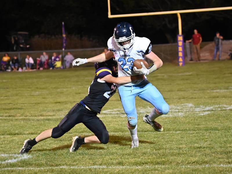Eagles freshman Coltyn Kelley works to run through a tackle by Murray’s Wylee Wright Friday in a 64-40 East Union win.