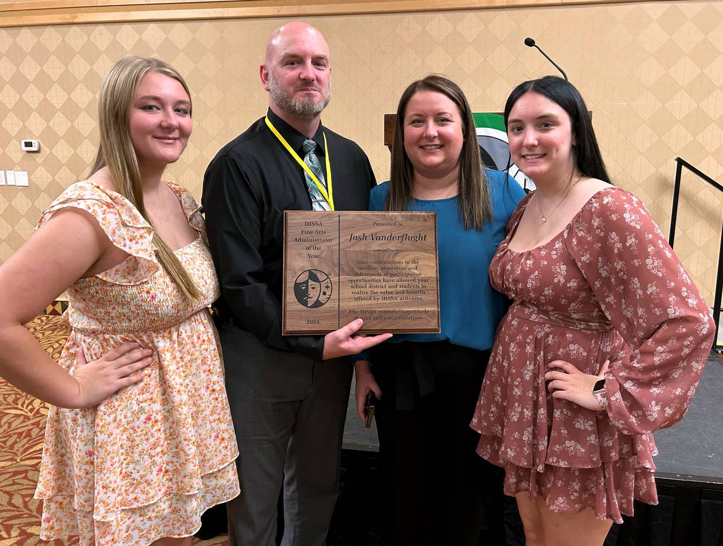 Josh Vanderflught and his family smile after the award is given. From left, daughter Ella, Josh, wife Courtney and daughter Olivia.