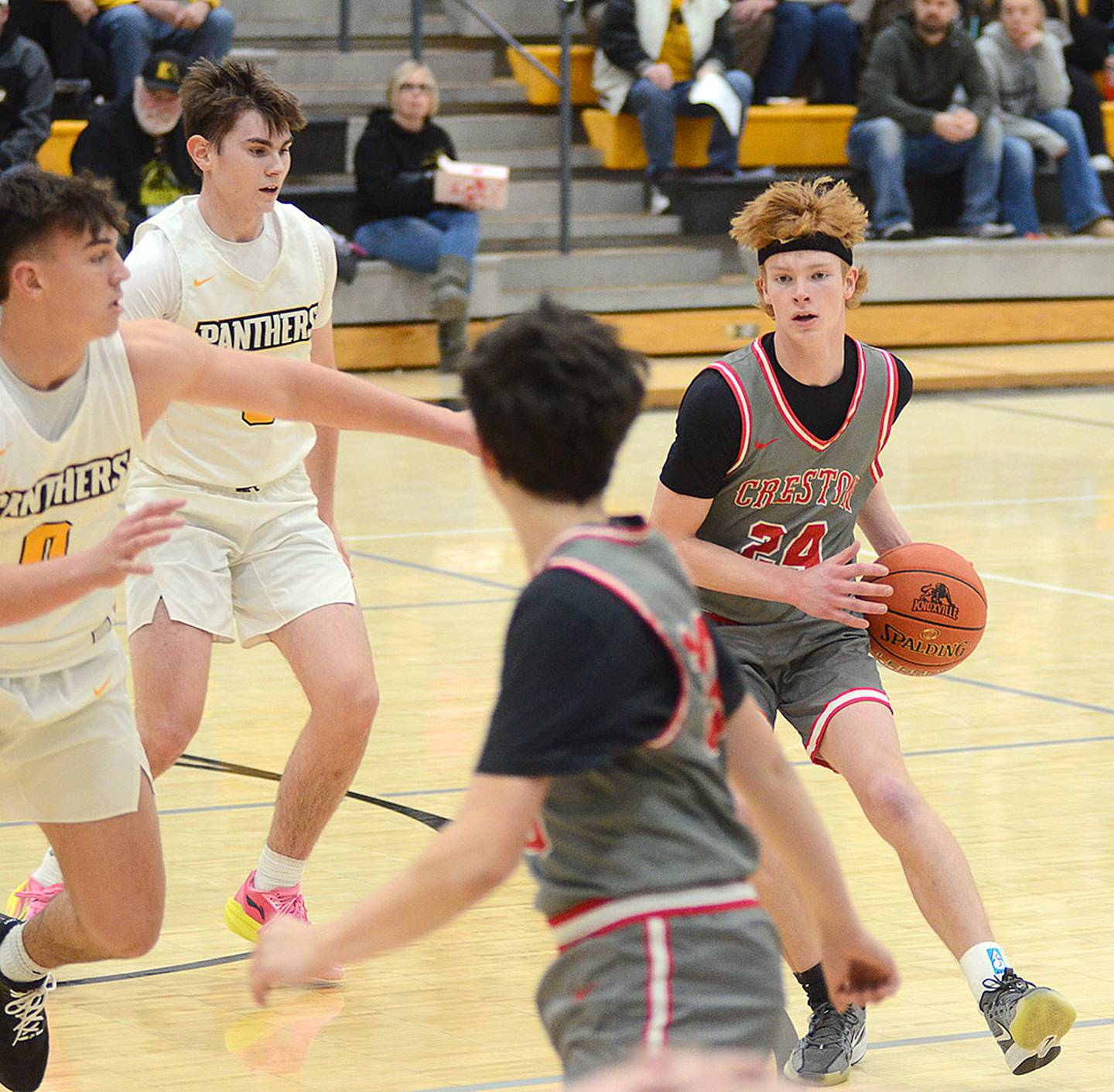 Creston guard Tanner Ray (24) looks to pass to teammate Jaxson Schaffer during Monday's game.