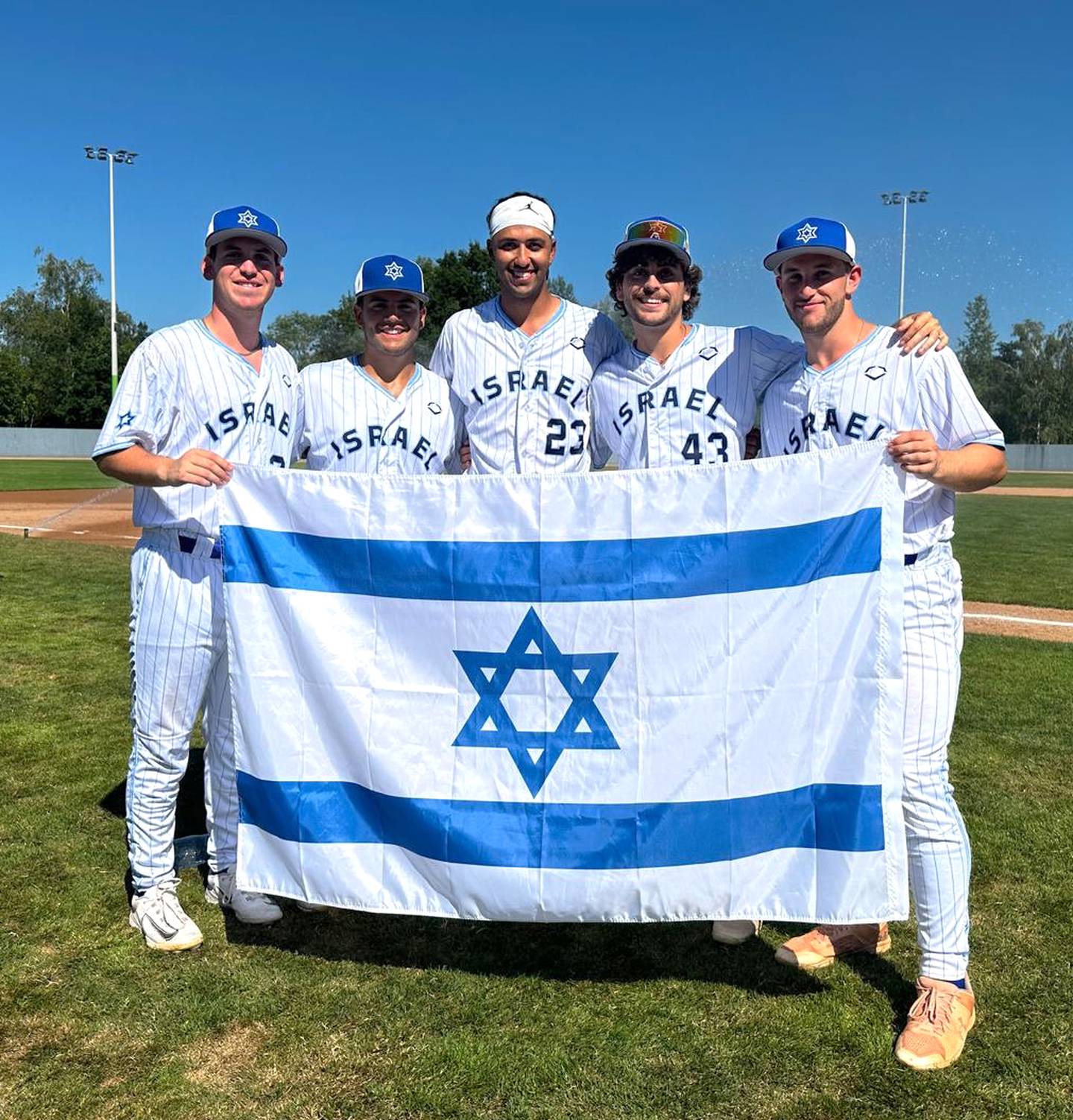 Ido Peled, left, stands with Israeli teammates while on the national team.