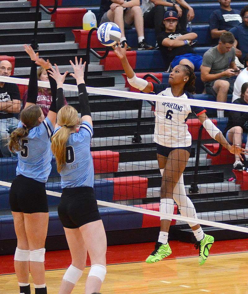 Southwestern sophomore Skyelar Lawal tips the ball past two Southeast blockers during Monday's home match. Lawal had five kills and two blocks in the 3-1 loss.