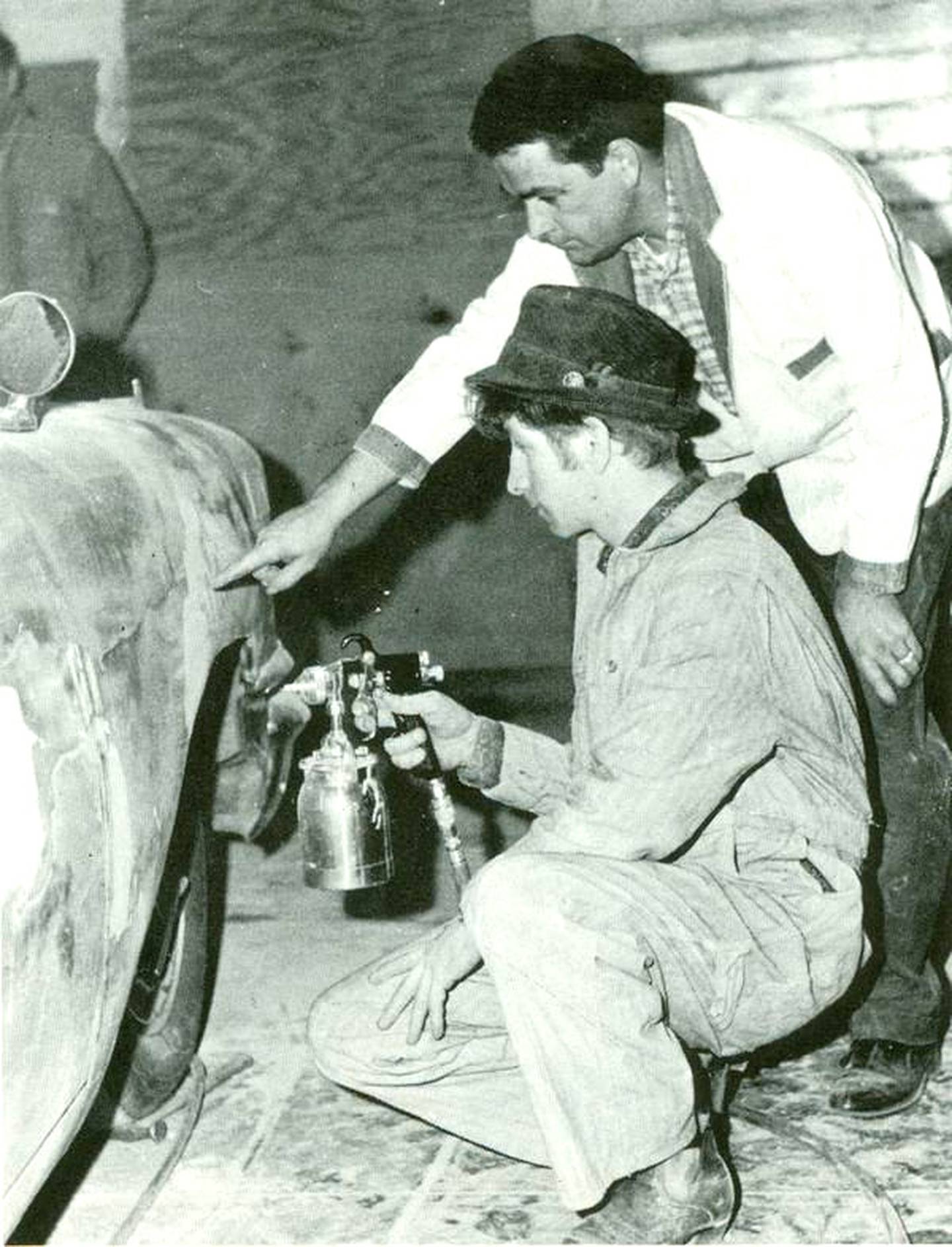Gordon Bills, former Southwestern Community College automotive instructor, helps former student Phil Miller work on a car in 1967.