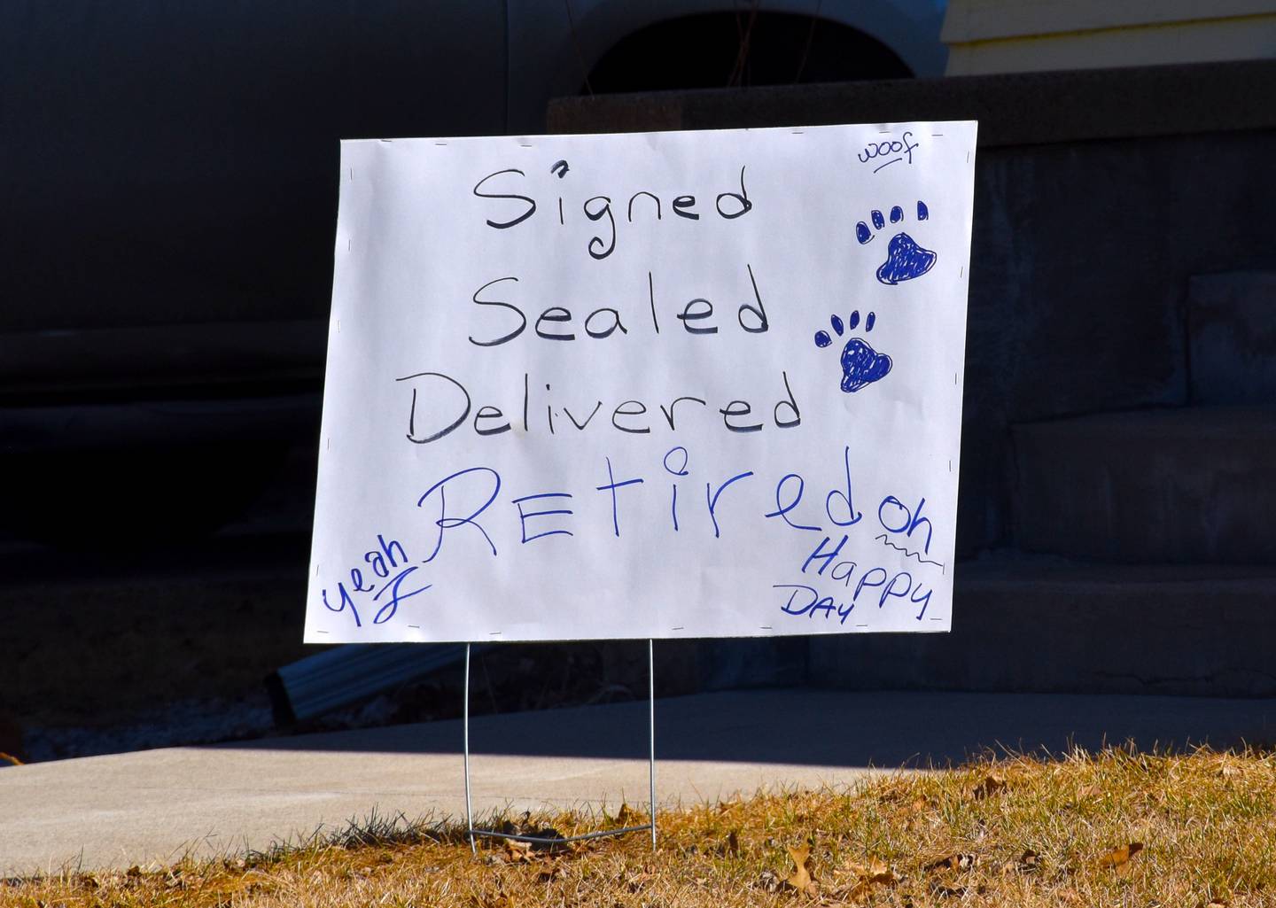 "Signed, sealed, delivered, retired" says a sign during Evans's last day as a letter carrier.